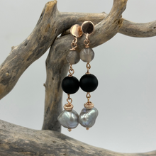 Load image into Gallery viewer, Make a statement with these 18K Rose gold plated over sterling silver stud style earrings. They feature three stunning elements - silver grey Freshwater Pearls, black agate and smokey quartz. Each element is highlighted with Rose gold links.
Pearls measure 10mm.
Total length from top to bottom is 50mm.
