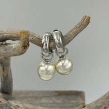 Load image into Gallery viewer, These stunning Huggie style 'Clip On' earrings feature a large detachable Shell pearl.
The pearls are Circle Drop shape, 13.5 x 16.5mm in size and Cream champagne in color.
These pearls are Faux and created from shell in resin
Available in Silver, Yellow gold or Rose gold look settings
See the photos below 