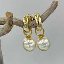 Load image into Gallery viewer, These stunning Huggie style 'Clip On' earrings feature a large detachable Shell pearl.
The pearls are Circle Drop shape, 13.5 x 16.5mm in size and Cream champagne in color.
These pearls are Faux and created from shell in resin
Available in Silver, Yellow gold or Rose gold look settings
See the photos below 