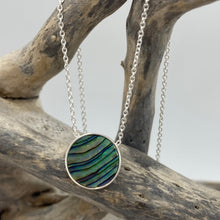 Load image into Gallery viewer, Sterling silver pendant and chain featuring a round bezel set reversible disc of Blue Paua shell on one side and White Mother of Pearl shell on the other side.
Disc size is 14mm in diameter and 2.5mm in thickness with an adjustable chain length from 39cm to 42cm