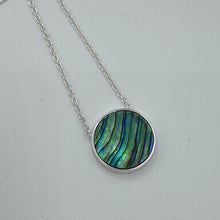 Load image into Gallery viewer, Sterling silver pendant and chain featuring a round bezel set reversible disc of Blue Paua shell on one side and White Mother of Pearl shell on the other side.
Disc size is 14mm in diameter and 2.5mm in thickness with an adjustable chain length from 39cm to 42cm