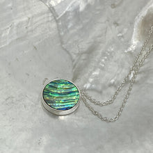 Load image into Gallery viewer, Sterling silver pendant and chain featuring a round bezel set reversible disc of Blue Paua shell on one side and White Mother of Pearl shell on the other side.
Disc size is 14mm in diameter and 2.5mm in thickness with an adjustable chain length from 39cm to 42cm