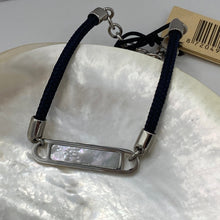 Load image into Gallery viewer, Stunning new range of Ladies Stainless steel and nautical rope jewellery, hand made in Amsterdam and designed with strength to be worn 24/7
This stunning rope Mother of Pearl shell bracelet with Navy Blue rope and Silver fittings is the perfect bracelet for a touch of glowing shell teamed with the classy rope and durability of stainless steel setting around the pearl shell
One size
Also available in other colors
Mix and match or stack with other Pig and Hen bracelets 