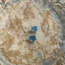 Load image into Gallery viewer, <p>Sterling silver claw set shepherds hook style earrings featuring stunning Rough cut Aquamarine gemstones</p> <p>The stones vary in shape but are roughly rectangle and 11 x 12mm in size</p> <p>Team your aquamarine earrings with an aquamarine necklace for a WOW effect</p>