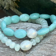 Load image into Gallery viewer, <p>Stunning Amazonite bracelet featuring a white Australian South Sea Pearl</p> <p>Pearl is circle drop in shape, and is 11.2 x 12.5mm in size and white in colour</p> <p>The Amazonite beads are flat oval facetted and are 10 x 16mm in size</p> <p>This bracelet is easy to slip on and off as it's made on elastic</p> <p>J3360</p>