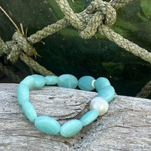 Load image into Gallery viewer, <p>Stunning Amazonite bracelet featuring a white Australian South Sea Pearl</p> <p>Pearl is circle drop in shape, and is 11.2 x 12.5mm in size and white in colour</p> <p>The Amazonite beads are flat oval facetted and are 10 x 16mm in size</p> <p>This bracelet is easy to slip on and off as it's made on elastic</p> <p>J3360</p>