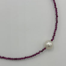 Load image into Gallery viewer, Australian South Sea pearl necklace with 2mm faceted deep red ruby gemstones and a 925 Sterling silver parrot clasp. This stunning necklace features a single White Australian South Sea pearl , Round in shape, 9.3mm in size, and White with Pink hues in color. This pearl has excellent lustre and is AAA grade The overall length is 48cm J3449