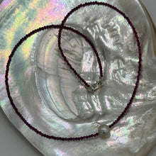 Load image into Gallery viewer, Australian South Sea pearl necklace with 2mm faceted deep red ruby gemstones and a 925 Sterling silver parrot clasp. This stunning necklace features a single White Australian South Sea pearl , Round in shape, 9.3mm in size, and White with Pink hues in color. This pearl has excellent lustre and is AAA grade The overall length is 48cm J3449