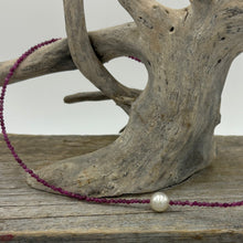 Load image into Gallery viewer, Australian South Sea pearl necklace with 2mm faceted deep red ruby gemstones and a 925 Sterling silver parrot clasp. This stunning necklace features a single White Australian South Sea pearl , Round in shape, 9.3mm in size, and White with Pink hues in color. This pearl has excellent lustre and is AAA grade The overall length is 48cm J3449