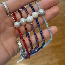 Load image into Gallery viewer, <p><span>Australian South Sea pearl necklace with facetted 3mm Garnet gemstones and a sterling silver peanut clasp</span></p> <p><span>This stunning necklace features an Australian South Sea pearl , Button in shape, and 12.1mm in size. It is white with Subtle Pink hues in color</span></p> <p>The overall length is 46.5cm</p> <p>Good lustre and light natural 'birthmarks'</p> <p><span>J3345</span></p>