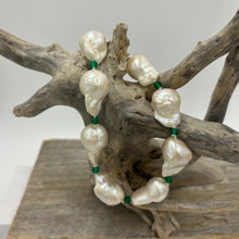 Load image into Gallery viewer, This stunning baroque Freshwater pearl bracelet features Eight High lustre pearls, 13 x 21mm in size and white in colour. These pearls are highlighted between each pearl with a facetted 4mm Green Onyx gemstones. It has a rhodium coated non tarnish 925 Sterling Silver clasp. The length including clasp is 22cm.