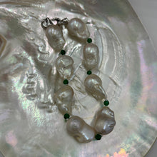 Load image into Gallery viewer, This stunning baroque Freshwater pearl bracelet features Eight High lustre pearls, 13 x 21mm in size and white in colour. These pearls are highlighted between each pearl with a facetted 4mm Green Onyx gemstones. It has a rhodium coated non tarnish 925 Sterling Silver clasp. The length including clasp is 22cm.