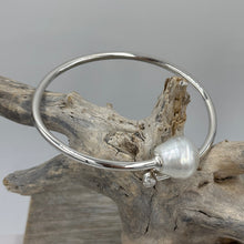 Load image into Gallery viewer, Sterling Silver solid bangle featuring an Australian South Sea Pearl and a bezel set cubic zirconia at either end
This stunning pearl is an Australian South Sea pearl, Circle Drop in shape and 13.8 x 15mm in size. It has high lustre and light natural birthmarks
It is White with Silver Pink hues and is featured on this non tarnish wrap bangle
J3508