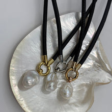 Load image into Gallery viewer, 'Jennifer' is a unique necklace of soft lamb leather, stainless steel fittings and a detachable large baroque shaped Freshwater Pearl.
The pearl is white with silver pink hues and is 18 x 25mm in size
Evelyn is available in Silver, Gold or Rose colors
The length of the leather band is 45cm 