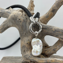 Load image into Gallery viewer, 'Jennifer' is a unique necklace of soft lamb leather, stainless steel fittings and a detachable large baroque shaped Freshwater Pearl.
The pearl is white with silver pink hues and is 18 x 25mm in size
Evelyn is available in Silver, Gold or Rose colors
The length of the leather band is 45cm 