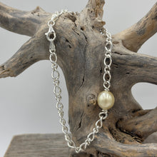 Load image into Gallery viewer, Australian South Sea Pearl bracelet featuring a single Champagne South Sea pearl,
The pearl is Drop in shape 9.6 x 10.8mm in size, and Champagne to Light Gold in color.
It features on this Italian made Oval Figaro 925 sterling silver chain with Cartier clasp
Length in total is 20cm
J3522