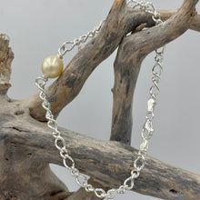 Load image into Gallery viewer, Australian South Sea Pearl bracelet featuring a single Champagne South Sea pearl,
The pearl is Drop in shape 9.6 x 10.8mm in size, and Champagne to Light Gold in color.
It features on this Italian made Oval Figaro 925 sterling silver chain with Cartier clasp
Length in total is 20cm
J3522