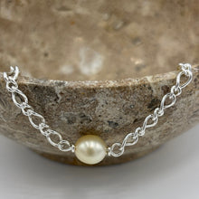 Load image into Gallery viewer, Australian South Sea Pearl bracelet featuring a single Champagne South Sea pearl,
The pearl is Drop in shape 9.6 x 10.8mm in size, and Champagne to Light Gold in color.
It features on this Italian made Oval Figaro 925 sterling silver chain with Cartier clasp
Length in total is 20cm
J3522