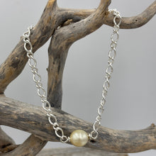 Load image into Gallery viewer, Australian South Sea Pearl bracelet featuring a single Champagne South Sea pearl,
The pearl is Drop in shape 9.6 x 10.8mm in size, and Champagne to Light Gold in color.
It features on this Italian made Oval Figaro 925 sterling silver chain with Cartier clasp
Length in total is 20cm
J3522