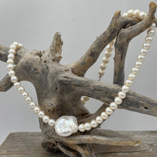 Load image into Gallery viewer, This unusual Freshwater pearl necklace/ strand features 6.5mm white Button shape pearls unknotted, with a central feature of a flattish baroque pearl, white with rainbow hues and 18.5 x 19.5mm in size and high lustre
It has a 925 sterling silver Cartier or lobster clasp
The total length including clasp is 43cm
