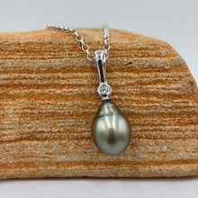 Load image into Gallery viewer, This Fijian South Sea pearl pendant enhancer is set on 925 Sterling silver with a bezel set cubic zirconia for added bling.
This pearl is Green in colour with natural Blue hues and is Circle Drop in shape, 11.1 x 14mm in size.
The lustre is good and the skin clean on this pearl
Chain included is Base metal only
J3429