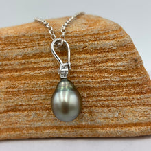 Load image into Gallery viewer, This Fijian South Sea pearl pendant enhancer is set on 925 Sterling silver with a bezel set cubic zirconia for added bling.
This pearl is Green in colour with natural Blue hues and is Circle Drop in shape, 11.1 x 14mm in size.
The lustre is good and the skin clean on this pearl
Chain included is Base metal only
J3429