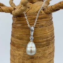 Load image into Gallery viewer, This Fijian South Sea pearl pendant enhancer is set on 925 Sterling silver with a bezel set cubic zirconia for added bling.
The pearl is Champagne in colour with Grey Pink hues making it a very unusual pearl especially combined with its Circle Long Drop shape.
It is 10.7 x 15mm in size, with Good lustre and very light 'birthmarks'
Chain included is Base metal only
J3427