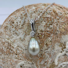 Load image into Gallery viewer, This Fijian South Sea pearl pendant enhancer is set on 925 Sterling silver with a bezel set cubic zirconia for added bling.
The pearl is Champagne in colour with Grey Pink hues making it a very unusual pearl especially combined with its Circle Long Drop shape.
It is 10.7 x 15mm in size, with Good lustre and very light 'birthmarks'
Chain included is Base metal only
J3427