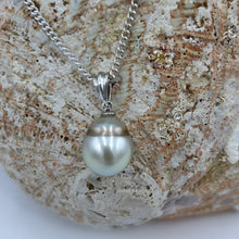 Load image into Gallery viewer, Unusual Fijian South Sea pearl pendant set on a simple 9ct White gold fitting.
This pearl is has a natural 'brown' circle birth mark around it giving a halo effect to the Pastel Blue Grey color of the pearl. It is Drop shape, 10.4 x 13mm in size.
The lustre is good and the skin clean on this pearl
Chain included is Base metal only
J3403