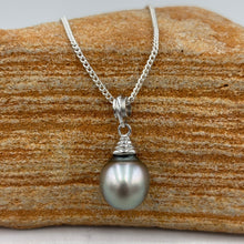 Load image into Gallery viewer, This pearl is an unusual pastel color with shades of Blue and Pink making it soft and wearable with anything. It is Drop shape, 10.5 x 13mm in size and has a natural circle birthmark at the top which blends well with the design of the pendant bail.
It is a stunning pearl with excellent lustre and clean skin
Chain included is Base metal only
J3401