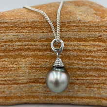 Load image into Gallery viewer, This pearl is an unusual pastel color with shades of Blue and Pink making it soft and wearable with anything. It is Drop shape, 10.5 x 13mm in size and has a natural circle birthmark at the top which blends well with the design of the pendant bail.
It is a stunning pearl with excellent lustre and clean skin
Chain included is Base metal only
J3401
