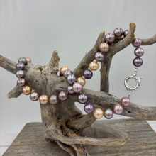 Load image into Gallery viewer, Stunning top quality natural colour Kasumi pearl strand featuring shades of natural pink, lavender and apricot. The lustre on these pearl is excellent.
This strand is 47cm long and the pearls are Round and 9 to 10.5mm in size.
They feature a 925 sterling silver 'Italian' Bolt Ring clasp that can be worn at the front and a pendant attached to it as a feature.