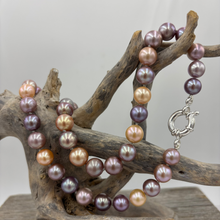 Load image into Gallery viewer, Stunning top quality natural colour Kasumi pearl strand featuring shades of natural pink, lavender and apricot. The lustre on these pearl is excellent.
This strand is 47cm long and the pearls are Round and 9 to 10.5mm in size.
They feature a 925 sterling silver 'Italian' Bolt Ring clasp that can be worn at the front and a pendant attached to it as a feature.
