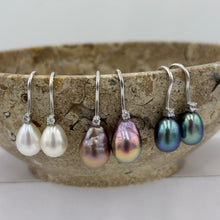 Load image into Gallery viewer, These elegant and classic Hook earrings are Sterling Silver and rhodium coated for a non tarnish finish and they feature a single claw set cubic zirconia above each pearl.
The pearls are tear drop shape, 9 x 12mm in size and white with pink hues in colour.
Also available with Black or Pink pearls to order