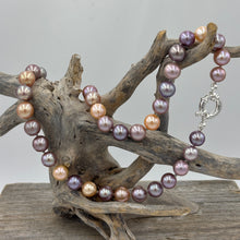 Load image into Gallery viewer, Stunning top quality natural colour Kasumi pearl strand featuring shades of natural pink, lavender and apricot. The lustre on these pearl is excellent.
This strand is 47cm long and the pearls are Round and 9 to 10.5mm in size.
They feature a 925 sterling silver 'Italian' Bolt Ring clasp that can be worn at the front and a pendant attached to it as a feature.