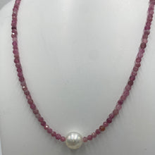 Load image into Gallery viewer, Australian South Sea pearl necklace with 2mm faceted deep red ruby gemstones and a 925 Sterling silver parrot clasp. This stunning necklace features a single White Australian South Sea pearl , Round in shape, 9.3mm in size, and White with Pink hues in color. This pearl has excellent lustre and is AAA grade The overall length is 48cm J3449
