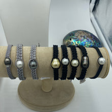 Load image into Gallery viewer, Thick Grey Macrame Bracelet featuring an Tahitian South Sea Pearl, Drop in shape, 11.8 x 13.1mm in size, Blue Green with Aubergine hues in colour. This bracelet is made from colour and water fast nylon material for heavy duty wear and tear, features no metal or glue. (J3318) Pictured on right in photo of three or third from left in group photo