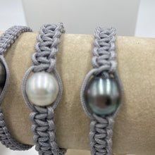 Load image into Gallery viewer, Thick Grey Macrame Bracelet featuring an Tahitian South Sea Pearl, Drop in shape, 11.8 x 13.1mm in size, Blue Green with Aubergine hues in colour. This bracelet is made from colour and water fast nylon material for heavy duty wear and tear, features no metal or glue. (J3318) Pictured on right in photo of three or third from left in group photo