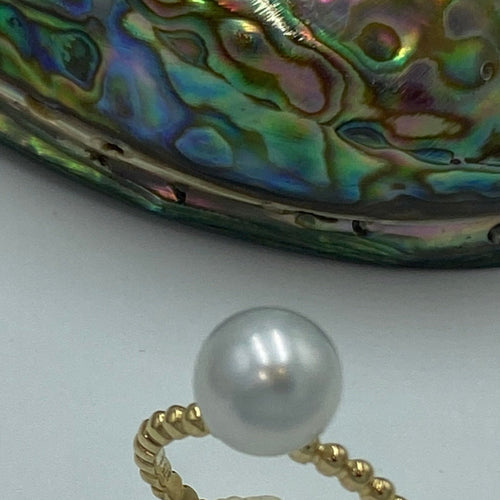 Australian  South Sea pearl ring which features a Round shape pearl, 9.2mm in size with High lustre and 'AAA' grade skin  It is White with silver hues and is set in a 9ct Yellow Gold band   Size N , 7, 54  J3298