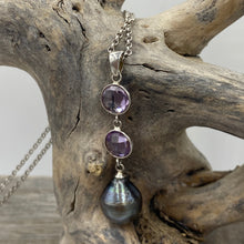 Load image into Gallery viewer, This pendant features two 8mm facetted Amethysts, and a Tahitian South Sea Pearl.
The pearl is Circle Drop in shape and 11mm in size. It is Dark Green with pink hues in color. It is crafted from 925 Sterling silver
It includes a 925 sterling silver chain that is adjustable in length from 45cm to 50cm
J3257
Matching earrings under same name
