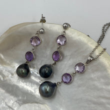 Load image into Gallery viewer, This pendant features two 8mm facetted Amethysts, and a Tahitian South Sea Pearl.
The pearl is Circle Drop in shape and 11mm in size. It is Dark Green with pink hues in color. It is crafted from 925 Sterling silver
It includes a 925 sterling silver chain that is adjustable in length from 45cm to 50cm
J3257
Matching earrings under same name