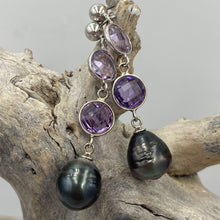 Load image into Gallery viewer, This pendant features two 8mm facetted Amethysts, and a Tahitian South Sea Pearl.
The pearl is Circle Drop in shape and 11mm in size. It is Dark Green with pink hues in color. It is crafted from 925 Sterling silver
It includes a 925 sterling silver chain that is adjustable in length from 45cm to 50cm
J3257
Matching earrings under same name