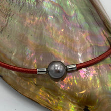 Load image into Gallery viewer, <p>Stunning Tahitian South Sea pearl necklet featuring a Near Round shape pearl that is 11.5mm in size and a beautiful Aubergine with Pink hues in color.</p> <p>This pearl has High lustre and is flawless. </p> <p>The necklace is leather and has a silver Cartier clasp and is a rich Pindan in color.</p> <p><span style="font-size: 0.875rem;">The length is adjustable from 44 to 47cm using the extension chain</span></p> <p><span style="font-size: 0.875rem;">J3350</span></p>