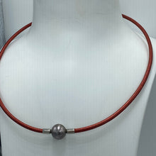 Load image into Gallery viewer, <p>Stunning Tahitian South Sea pearl necklet featuring a Near Round shape pearl that is 11.5mm in size and a beautiful Aubergine with Pink hues in color.</p> <p>This pearl has High lustre and is flawless. </p> <p>The necklace is leather and has a silver Cartier clasp and is a rich Pindan in color.</p> <p><span style="font-size: 0.875rem;">The length is adjustable from 44 to 47cm using the extension chain