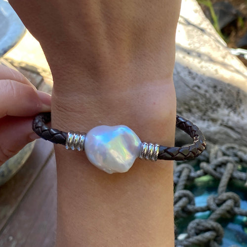 <p>'Pam DB' is a braided leather bracelet featuring a white Baroque Freshwater Pearl</p> <p>The pearl is baroque shape, 20 x 22mm in size and is white with silver hues in colour</p> <p>This bracelet is made out of braided dark brown leather and a stainless steel magnetic clasp</p>