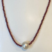 Load image into Gallery viewer, <p><span>Australian South Sea pearl necklace with facetted 3mm Garnet gemstones and a sterling silver peanut clasp</span></p> <p><span>This stunning necklace features an Australian South Sea pearl , Button in shape, and 12.1mm in size. It is white with Subtle Pink hues in color</span></p> <p>The overall length is 46.5cm</p> <p>Good lustre and light natural 'birthmarks'</p> <p><span>J3345</span></p>