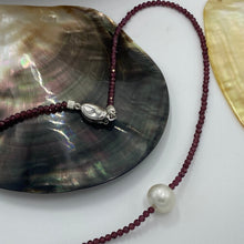 Load image into Gallery viewer, <p><span>Australian South Sea pearl necklace with facetted 3mm Garnet gemstones and a sterling silver peanut clasp</span></p> <p><span>This stunning necklace features an Australian South Sea pearl , Button in shape, and 12.1mm in size. It is white with Subtle Pink hues in color</span></p> <p>The overall length is 46.5cm</p> <p>Good lustre and light natural 'birthmarks'</p> <p><span>J3345</span></p>
