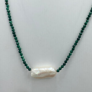 <p><span>This necklace features a white Freshwater BIWA Pearl on a necklace of 2.5mm facetted&nbsp; malachite gemstones with a sterling silver peanut clasp</span></p> <p><span>The pearl is 10 x 23mm in size</span></p> <p>The overall length is 45cm</p>