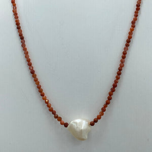 <p><span>This necklace features a white Freshwater Keshi or seedless Pearl&nbsp; on a necklace of 2.5mm facetted Red Bamboo Coral gemstones with a sterling silver peanut clasp</span></p> <p><span>The pearl is 11 x 12mm in size</span></p> <p>The overall length is 45cm</p> <p>Other gemstone necklaces can be made to order</p>