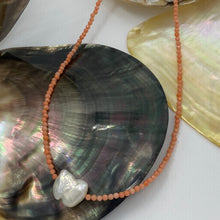 Load image into Gallery viewer, <p><span>This necklace features a white Freshwater Keshi or seedless Pearl on a necklace of 2.5mm facetted Orange Bamboo Coral gemstones with a sterling silver peanut clasp</span></p> <p><span>The pearl is 12.5 x 15mm in size</span></p> <p>The overall length is 46cm</p> <p>Other gemstone necklaces can be made to order</p>